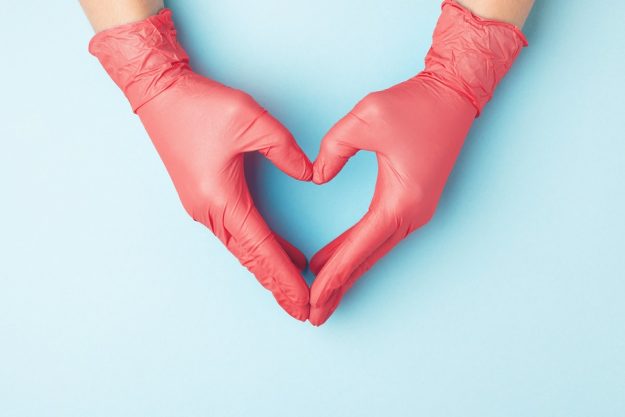 Doctor’s,Hands,In,Red,Medical,Gloves,In,Shape,Of,Heart